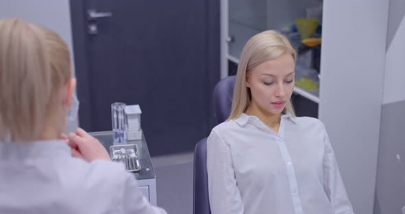 Doctor Puts a Medical Mask on His Face and Gloves Preparing for Work