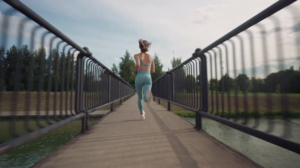 Woman Running in the Middle of the Bridge