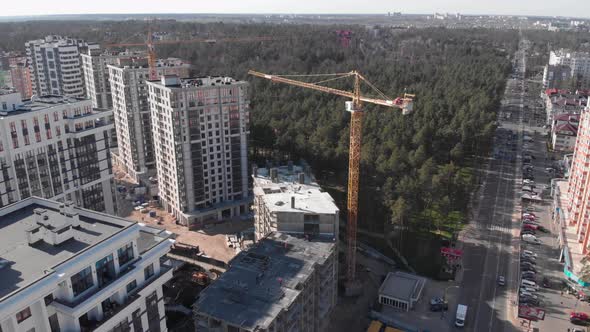 Building new modern residential complex near forest. Skyscrapers under construction.