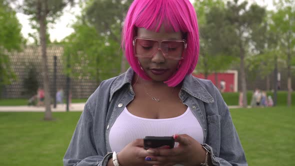 Portrait of Modern Attractive Black Woman with Smartphone Outdoors