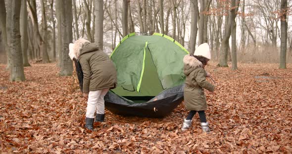 Black Race Sisters Putting a Tent in a Forest