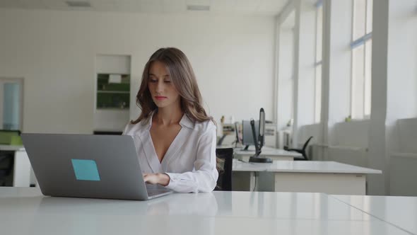 Slow Motion of a Young Worker Who Sits on Laptop