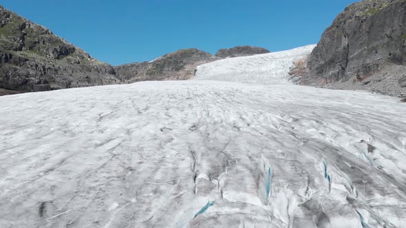 Aerial: receding glacier in mountain valley, global warming climate change