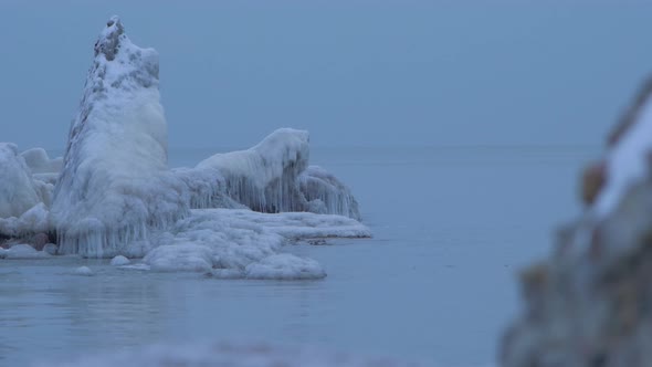 Small waves breaking against the ruins of Karosta Northern Forts fortification on the shore of Balti