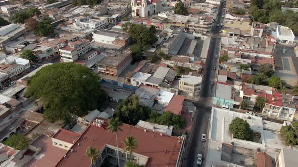 Aerial View Of City Of Colima In Mexico With Parish Of The Blood Of Christ Revealed. tilt-up