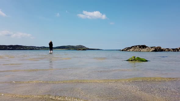 Woman Waking on Irish Beach in County Donegal