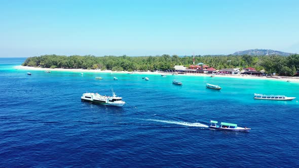 Island In Vanuatu - Boats Swiftly Sailing Over The Deep Blue Ocean Water Near The Lush Island On A S