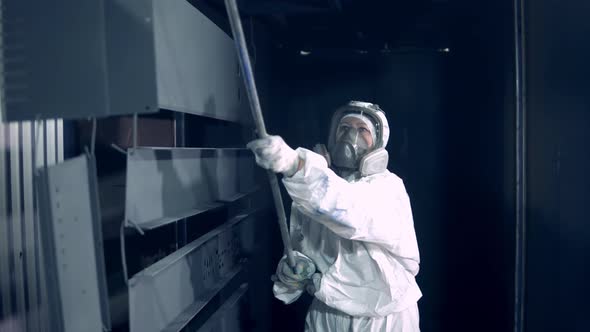 Female Worker in Safety Wear Is Transporting Hung Up Metal Plates