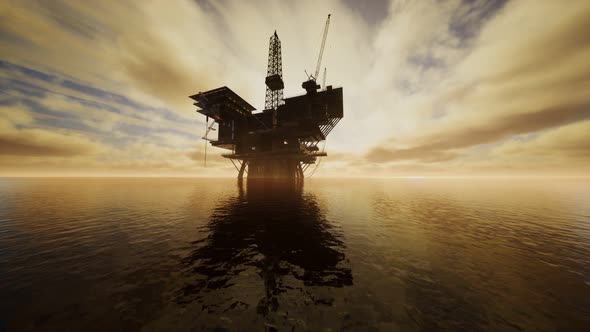 Offshore Jack Up Rig in The Middle of The Sea at Sunset Time alt