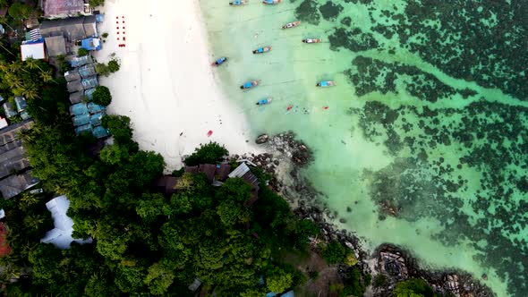 Beautiful coral reef at Pattaya beach at Koh Lipe Island Thailand during sunset, aerial tilt and rev