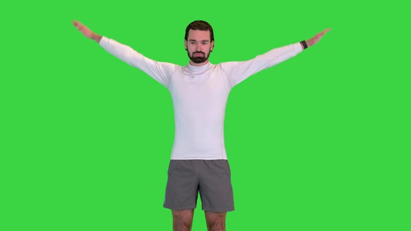 Healthy Man Rotating Hands to Warm Up Shoulders on a Green Screen Chroma Key