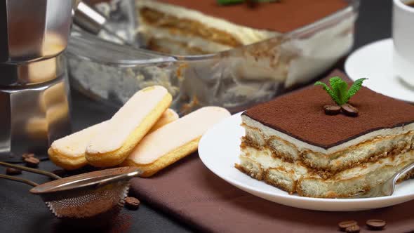 Portion of Traditional Italian Tiramisu Dessert Cup of Espresso and Baking Dish