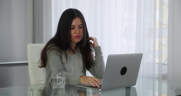 Freelancer Woman at Home Working on a Laptop