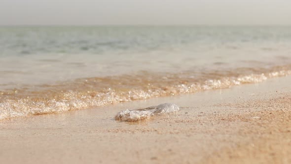 Polyethylene Bag and Plastic Bottle on Sand at Beach  Problem of Pollution