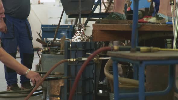 Glassmaker Opens Form to Take Off Bottle on Blowpipe in Shop