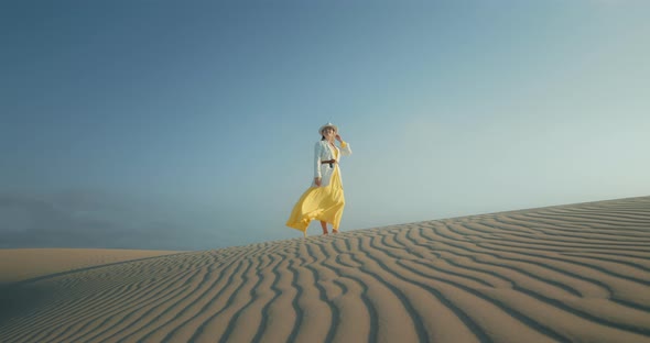 Slow Motion Woman in Stylish Safari Outfit Is Wavy Textured Sand Desert Surface