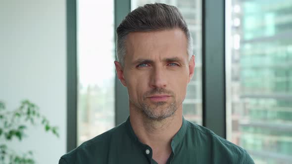 Successful Confident Mature Businessman Looking at Camera Standing in Office