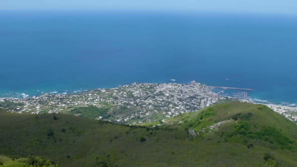 Overlook of Coastal City from Mountain Top Facing Azure Blue Calm Sea, Panorama