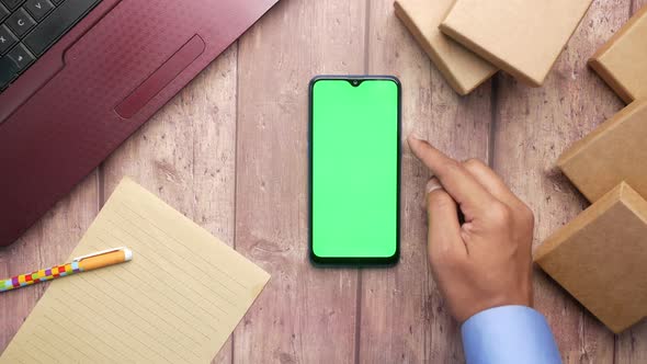 Stack of Cardboard Parcels  Smart Phone and Laptop on Table