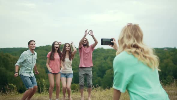 Friends Jumping And Having Fun While Taking Photos In Nature