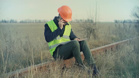 Foreman Designer On Train Station. Civil Engineer Developer With Helmet.Builder Constructor Foreman.