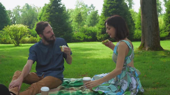 The Guy with the Girl Eat Salad Sandwiches on Picnic Washed Down with Coffee