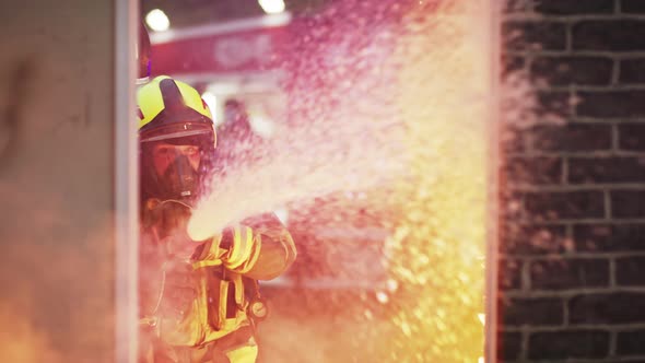 Fireman Extinguish Fire with the Hose. Burning House Fire Drill