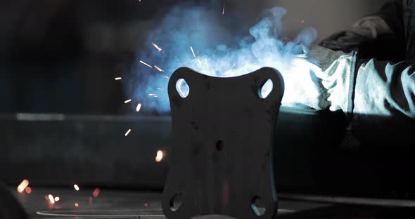 Steelworker Welding Base Plate To Metal Tubular Pipe - slow motion, slider shot