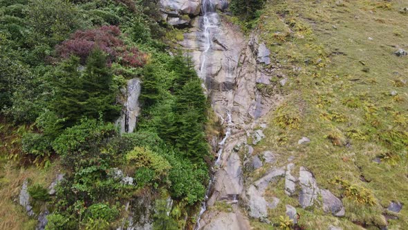 Waterfall in Rocky High Mountains in Cloud Weather