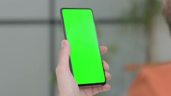 Close Up of Young Man Using Smartphone with Green Screen