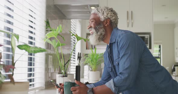 Video of african american senior man drinking coffee