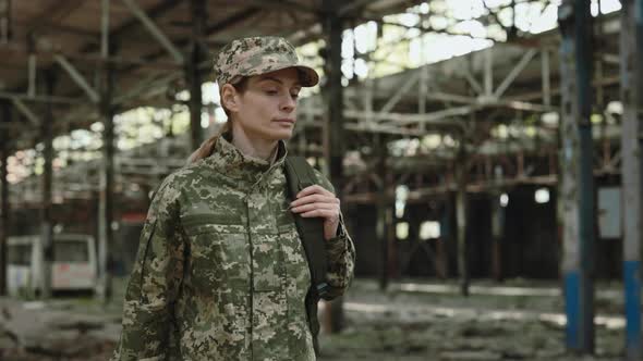 Soldier Walking Through Destroyed Manufactory After War