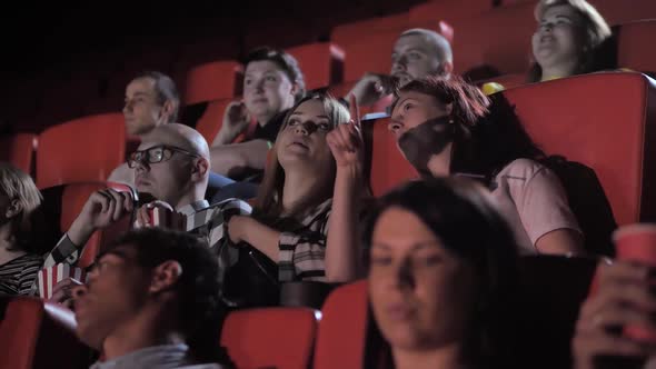 Lively Audience Chatting While Watching Movie