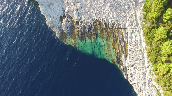 View from above of dangerous Dalmatian cliffs immersed in crystal clear sea