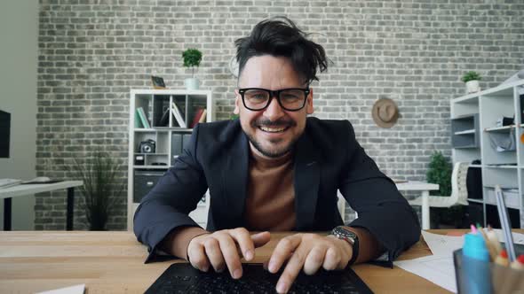 Mad Office Worker Typing Touching Keyboard Looking at Camera in Workplace