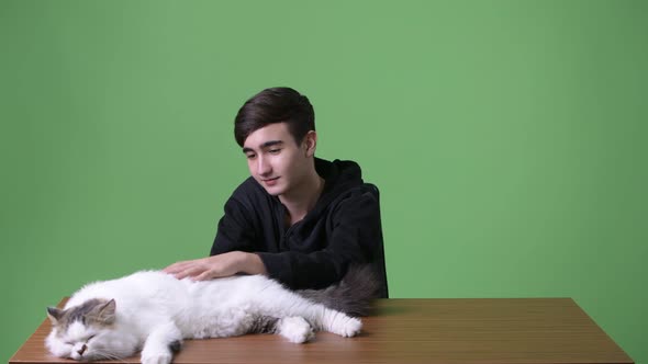 Young Handsome Iranian Teenage Boy Against Green Background