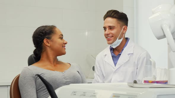 Young Cheerful Woman and Her Dentist Smiling To the Camera