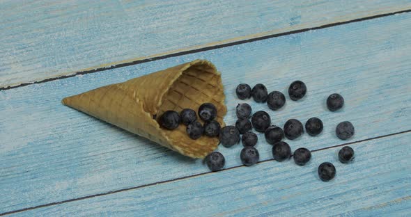 Berry Ice Cream Berries of Blueberries in a Waffle on a Blue Wooden Background