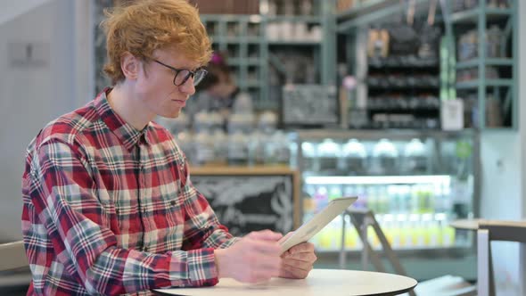 Loss, Young Redhead Man Reacting To Failure on Tablet