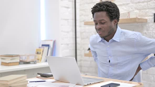 African Man Having Back Pain While Working