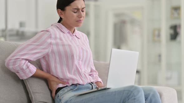 Tired Young Latin Woman with Laptop Having Back Pain at Home 