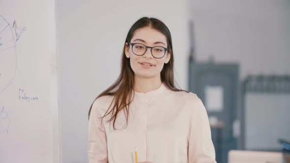 Happy Young Beautiful Millennial Business Woman Speaking at Modern Light Office Space, Corporate