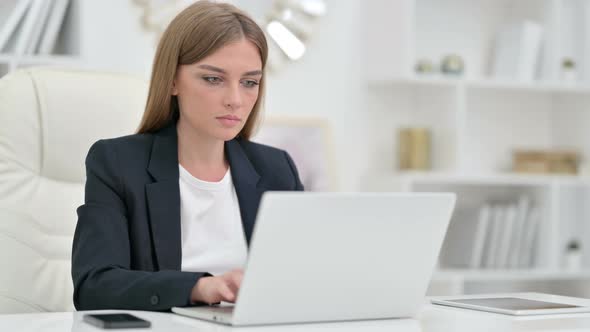 Serious Businesswoman with Laptop Saying No with Head Shake 