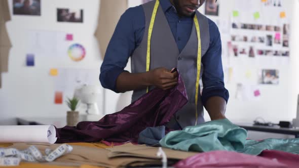 Mixed race man working in fashion office