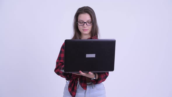 Happy Young Beautiful Hipster Woman Thinking While Using Laptop