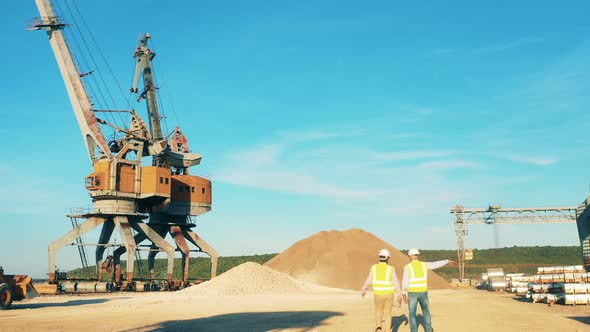 Industrial Loaders Are Working in a River Port in Daylight