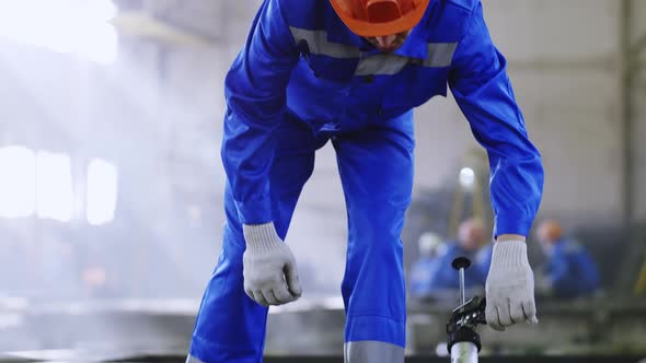 Manufacture worker using tool at plant