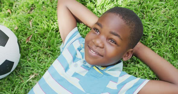 Animation of happy african american boy lying on lawn