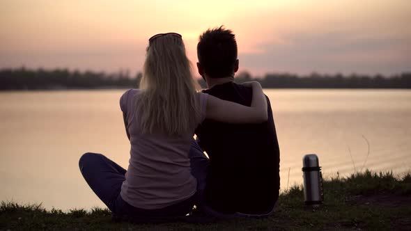 Loving Husband And Wife Enjoying Pleasant Conversation. Couple Relaxing And Watching On Sunset.