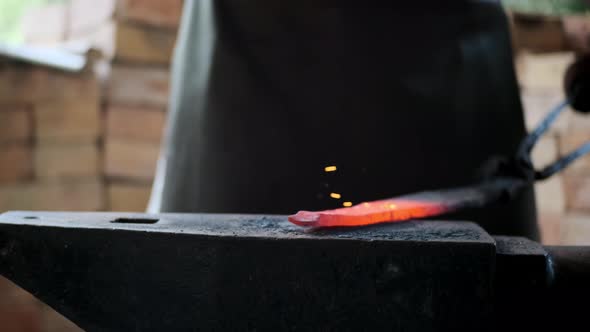 Blacksmith with Heavy Hammer Forges Spear in the Middle Ages